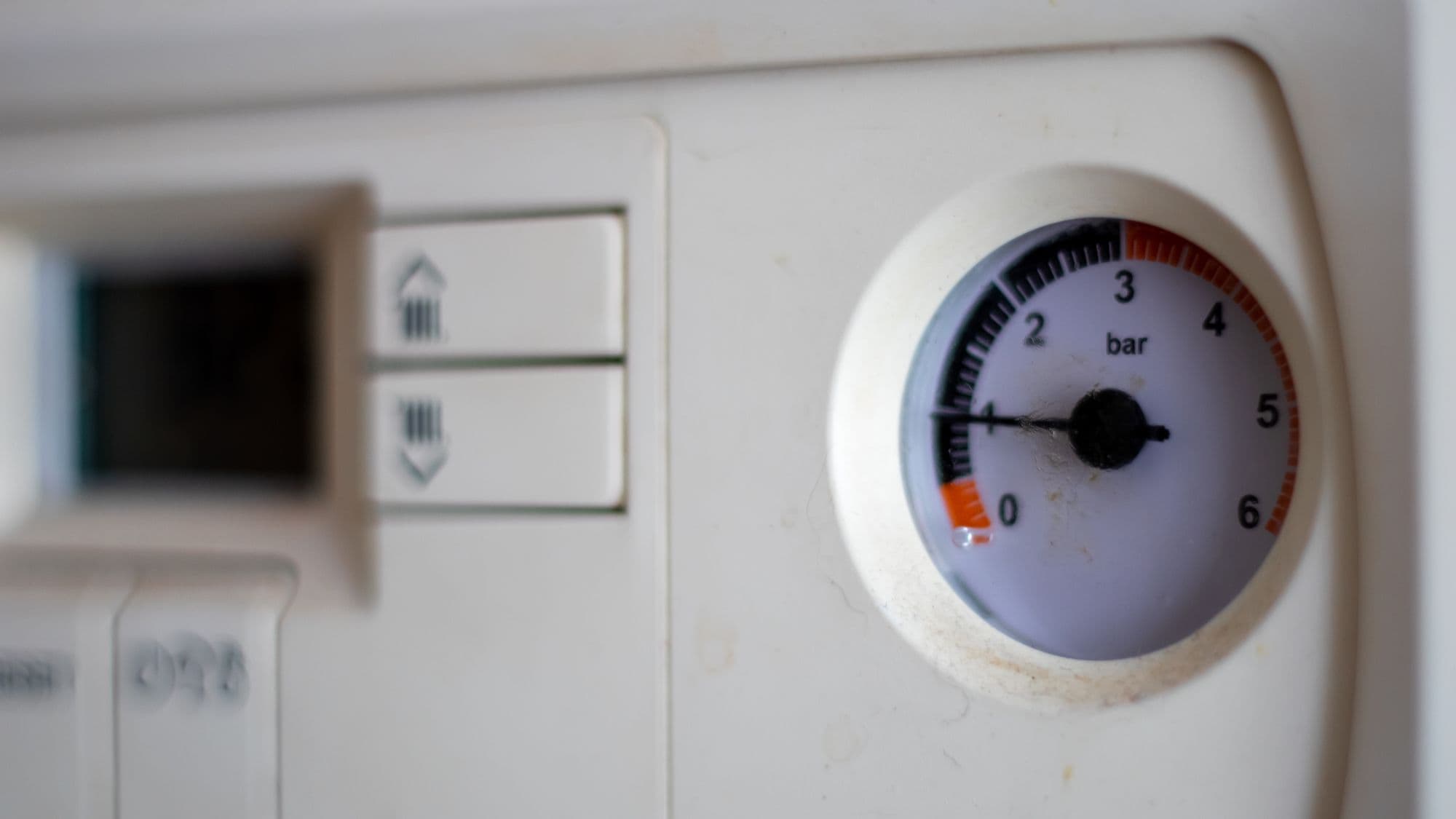 Close-up of a boiler pressure gauge reading about 1 bar