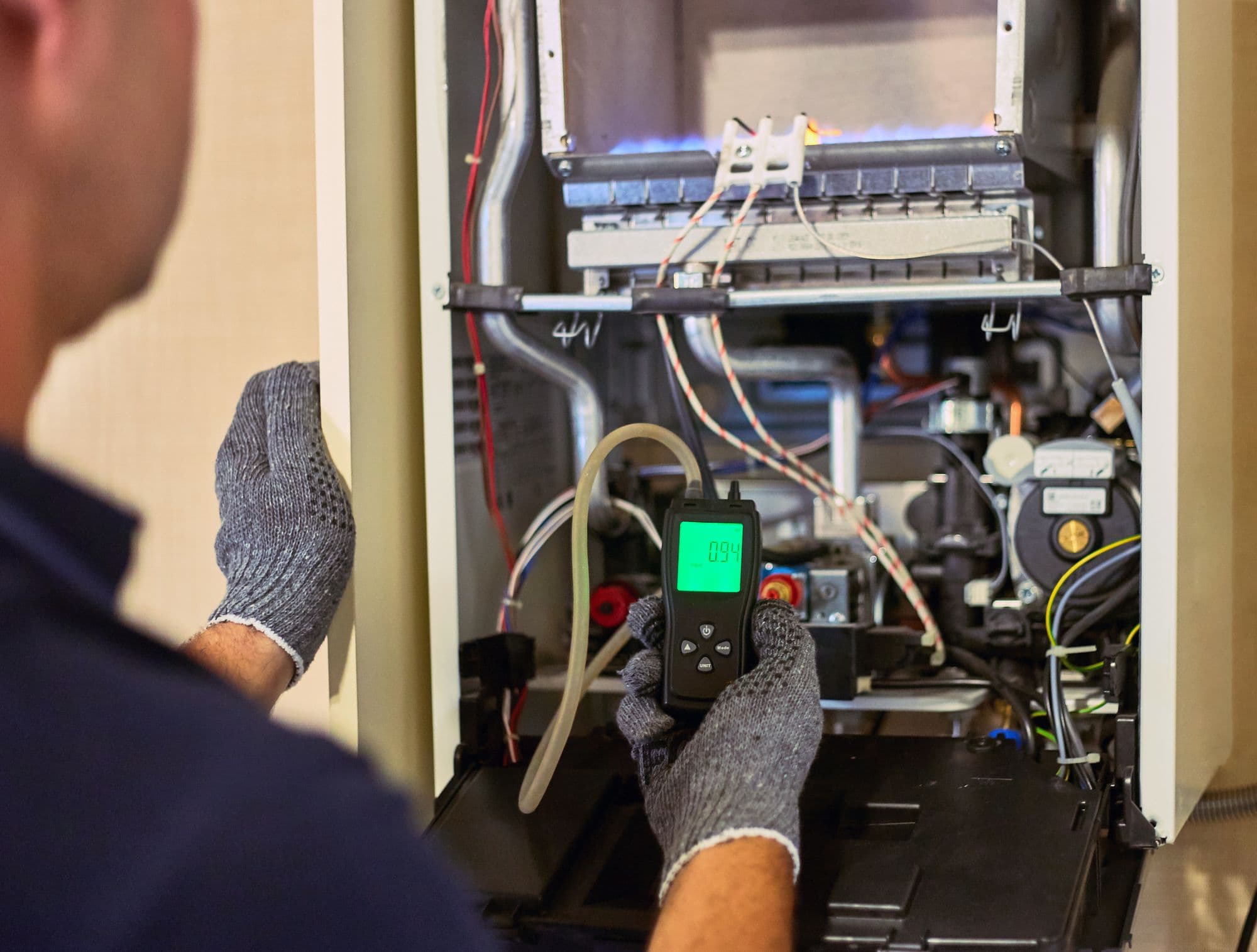 Engineer testing a boiler’s combustion with a flue gas analyser